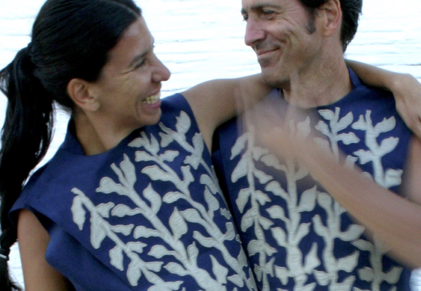 Two wearers embracing, activating the HugJackets